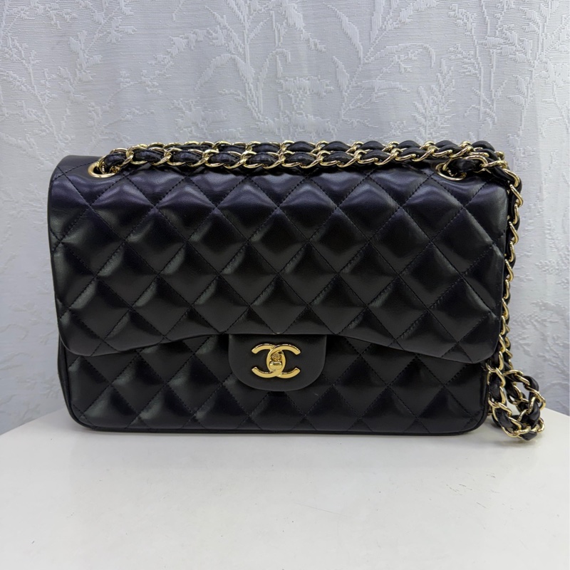 This is a Chanel Classic Double Flap bag in black leather with gold-tone hardware-0