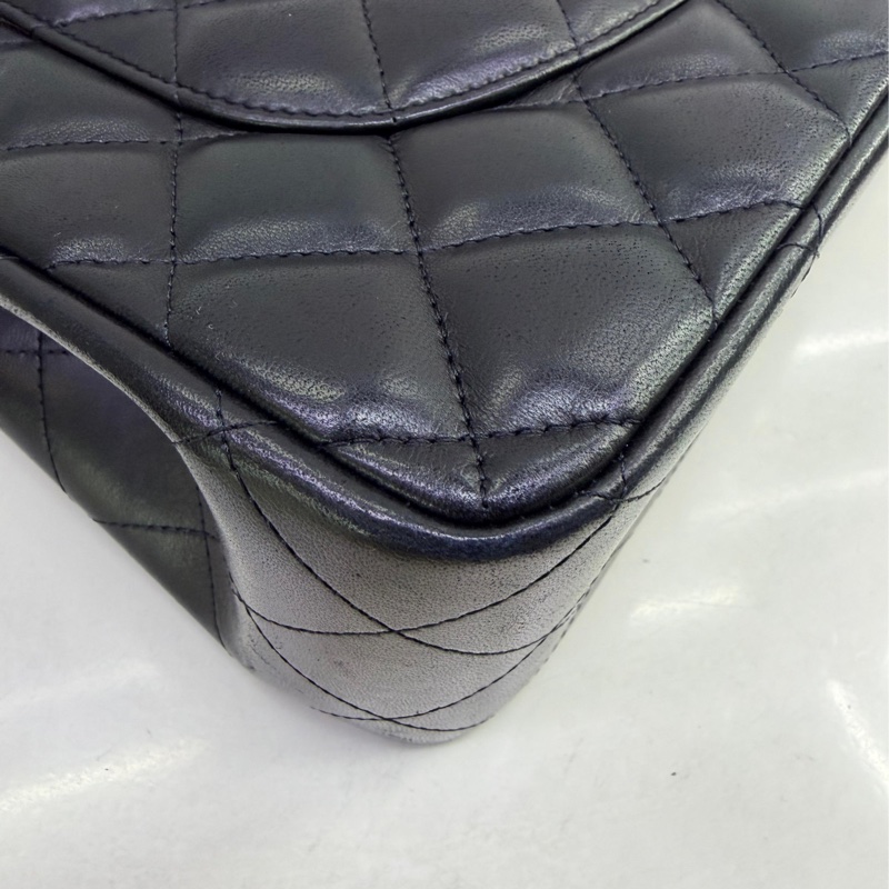 This is a Chanel Classic Double Flap bag in black leather with gold-tone hardware-4