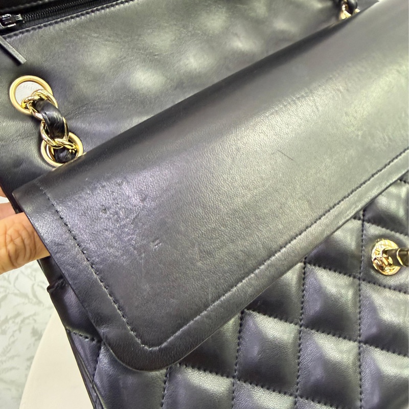 This is a Chanel Classic Double Flap bag in black leather with gold-tone hardware-7