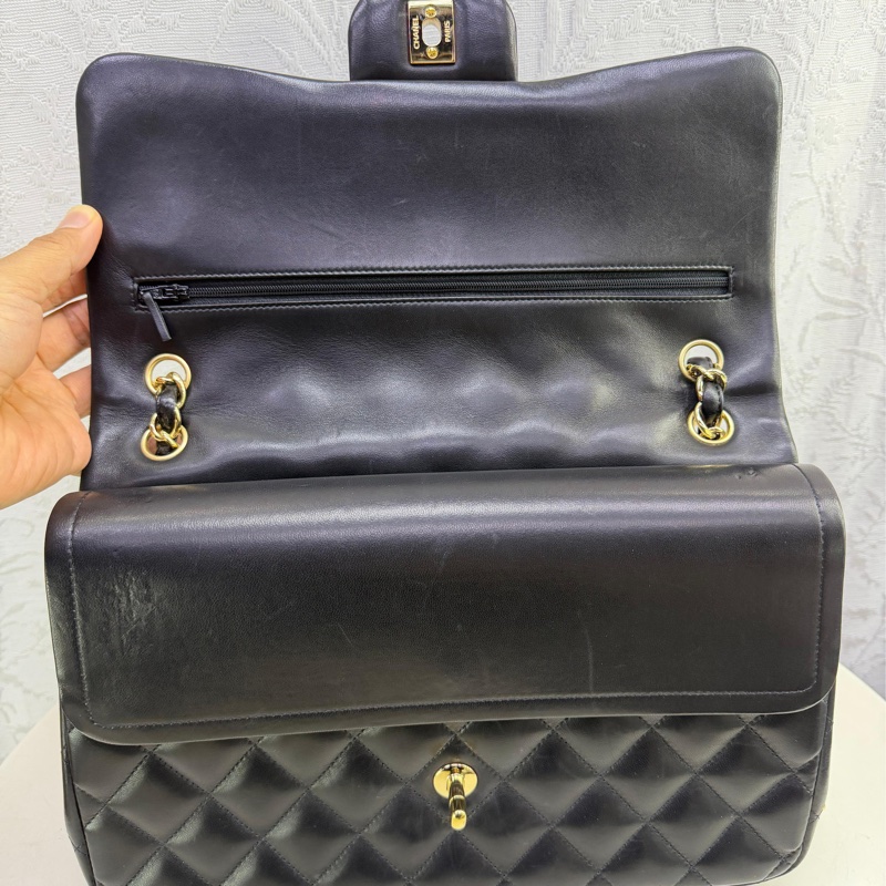 This is a Chanel Classic Double Flap bag in black leather with gold-tone hardware-14