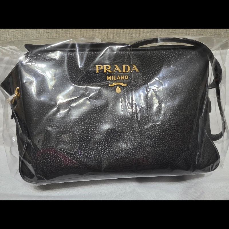 這是一件 Prada Vitello Phenix 黑色荔枝紋牛皮金色金屬標誌相機包。-7